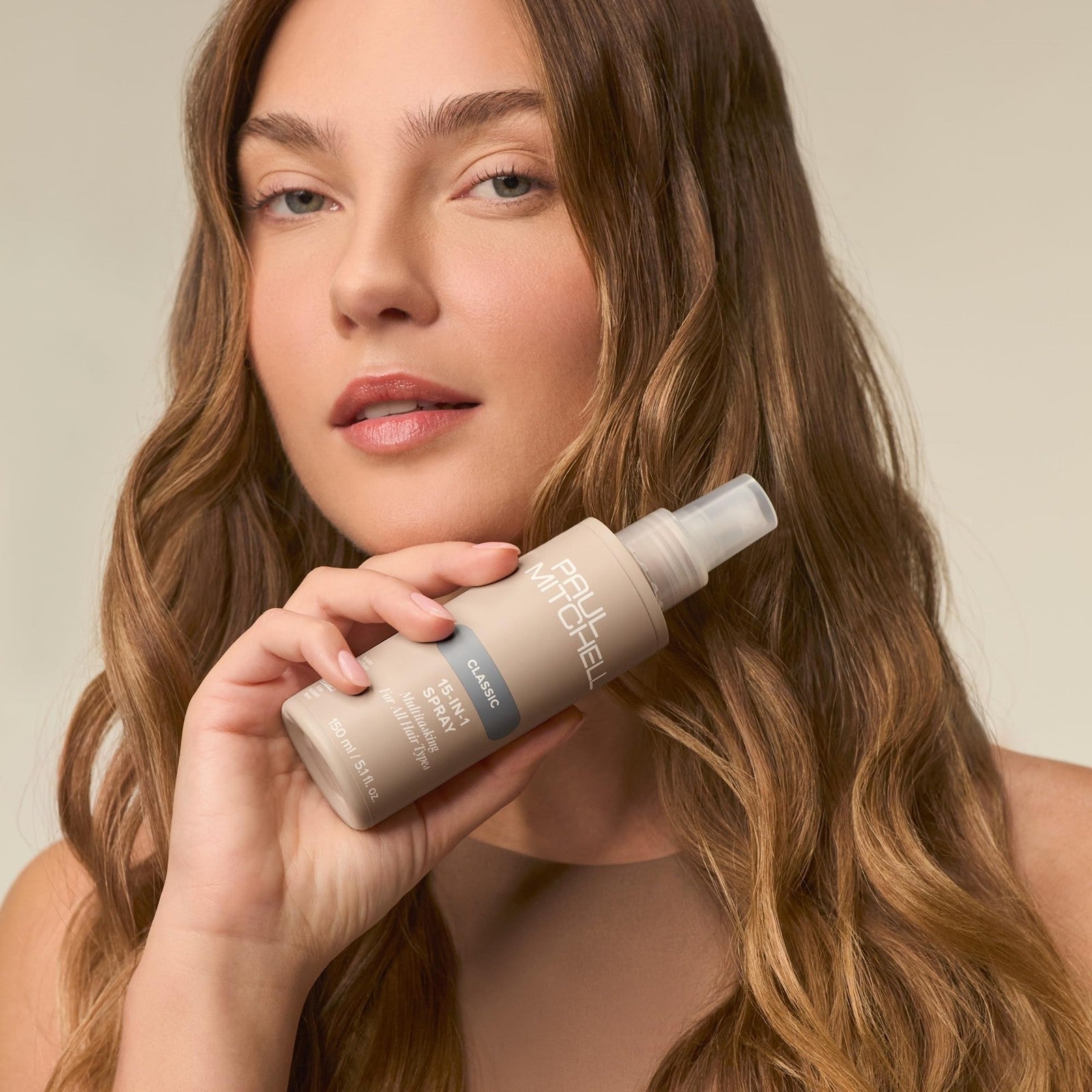 Paul Mitchell 15-In-1 Multitasking Spray bottle for all hair types, showing the 5.1 fl oz size with spray nozzle and label.