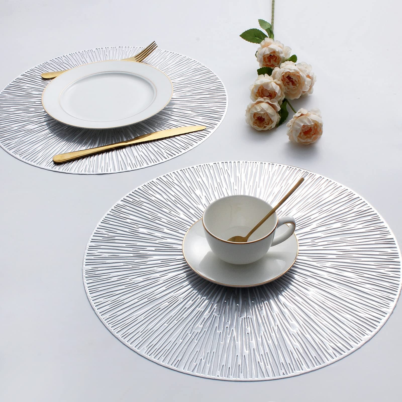 Evevda 8-piece round vinyl placemats for dining table, 15-inch pressed mats with hollow design set on a table.