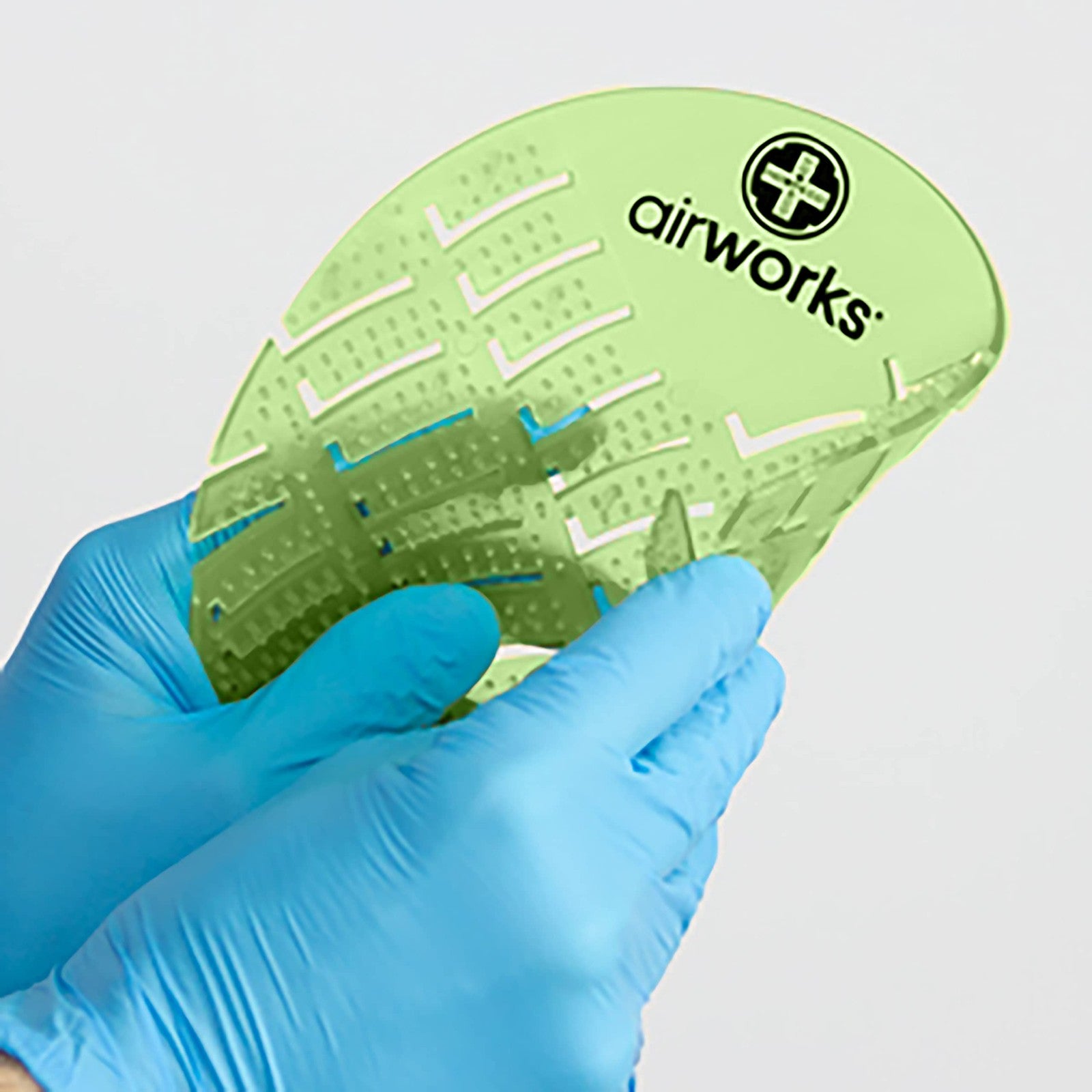 Light green herbal mint urinal screen from Hospeco Airworks AWUS002-BX pack, designed to freshen and mask odors.