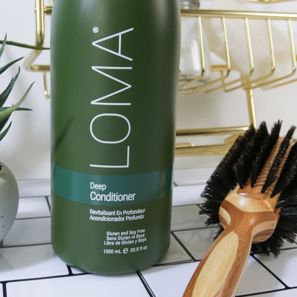 Loma Hair Care Deep Conditioner bottle, 33.8 fl oz, with creamy white formula and label featuring Loma branding and product details.