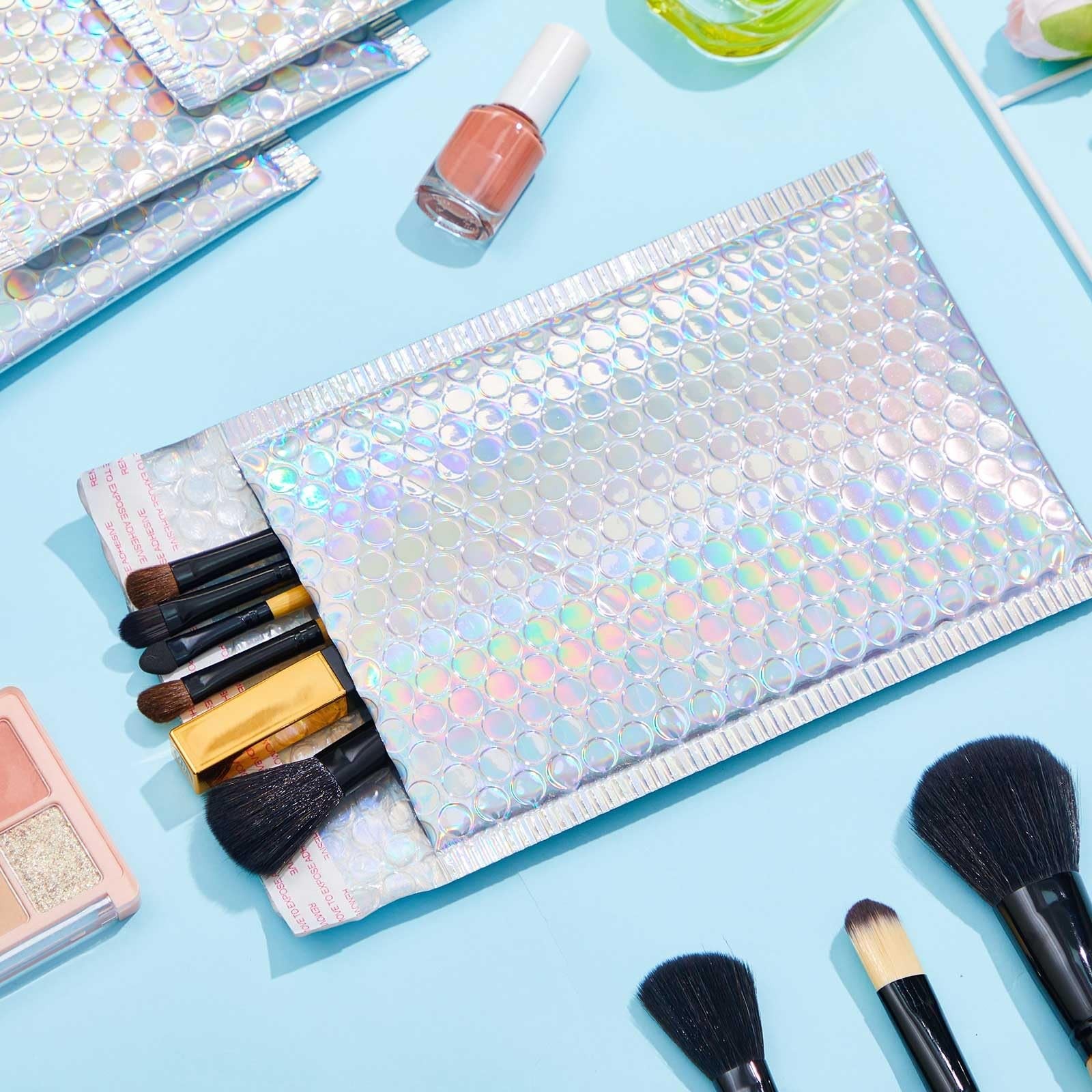 Set of 60 Henoyso 8x11.5 inch holographic bubble mailers with metallic finish, featuring padded bubble envelopes for secure shipping.
