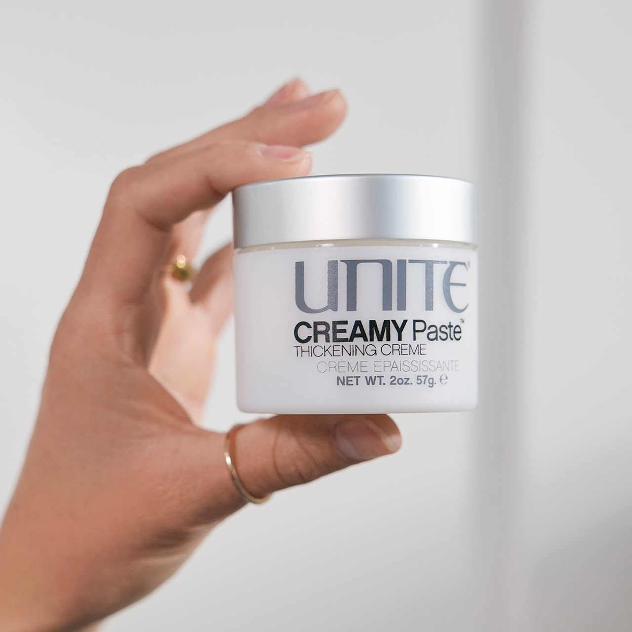 UNITE Hair Creamy Paste styling cream with a jar showing thick, textured hair for added thickness, texture, and definition.