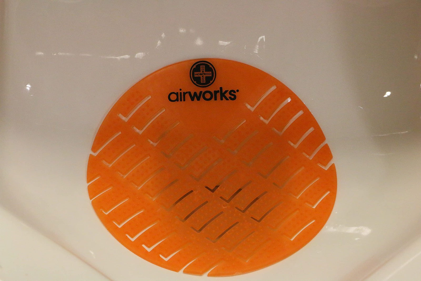 Set of 10 Mango Orange urinal deodorizer screens for air freshening, designed for effective odor control in restrooms.