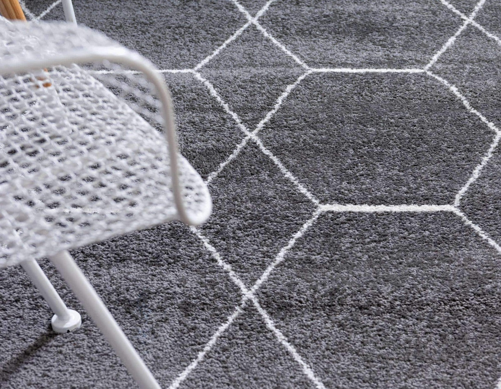 Dark gray geometric area rug from Unique Loom Trellis Frieze Collection featuring a pattern of 5 octagons on a textured surface.