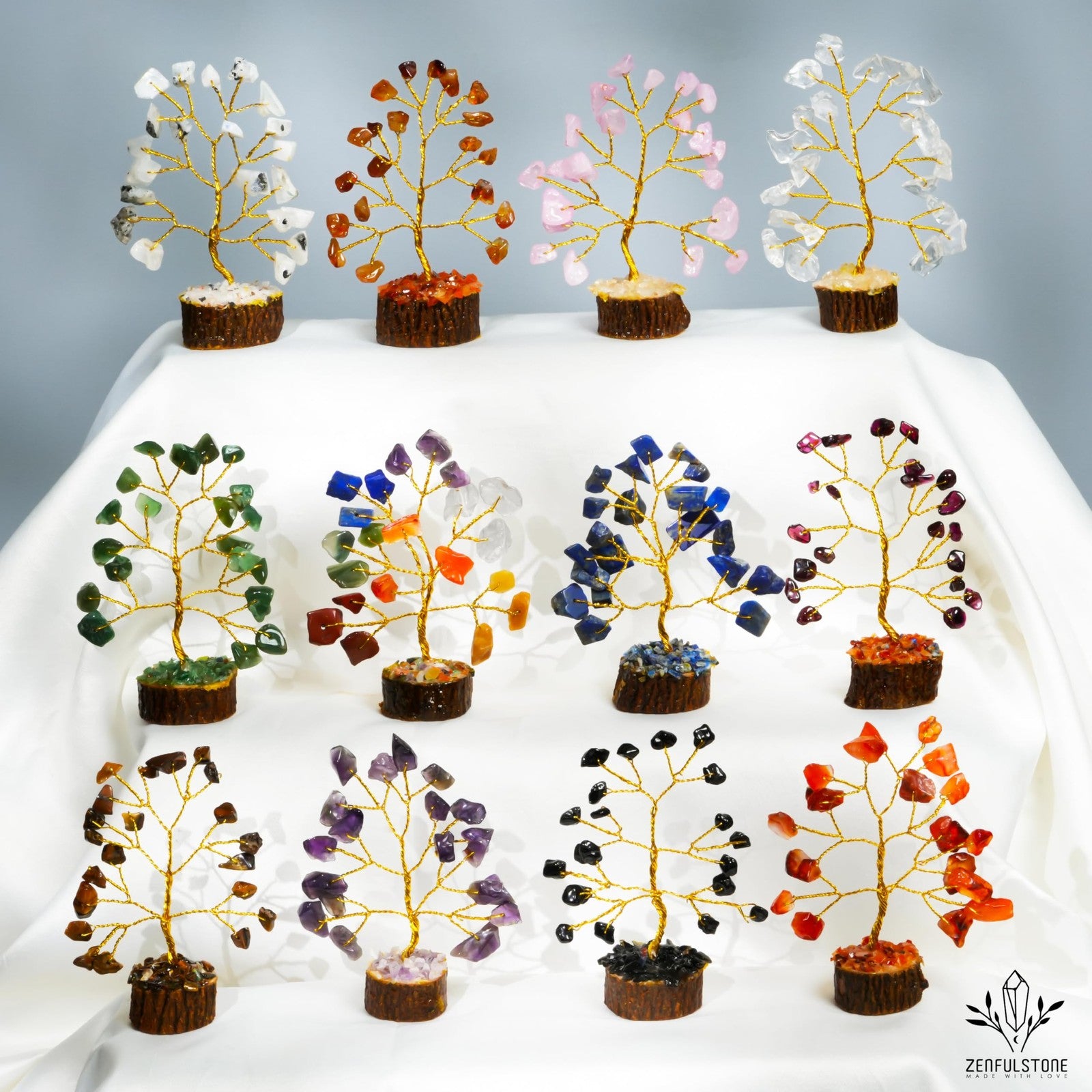 Set of 12 handcrafted crystal Tree of Life chakra gifts for women featuring small, detailed crystal trees with vibrant colors.