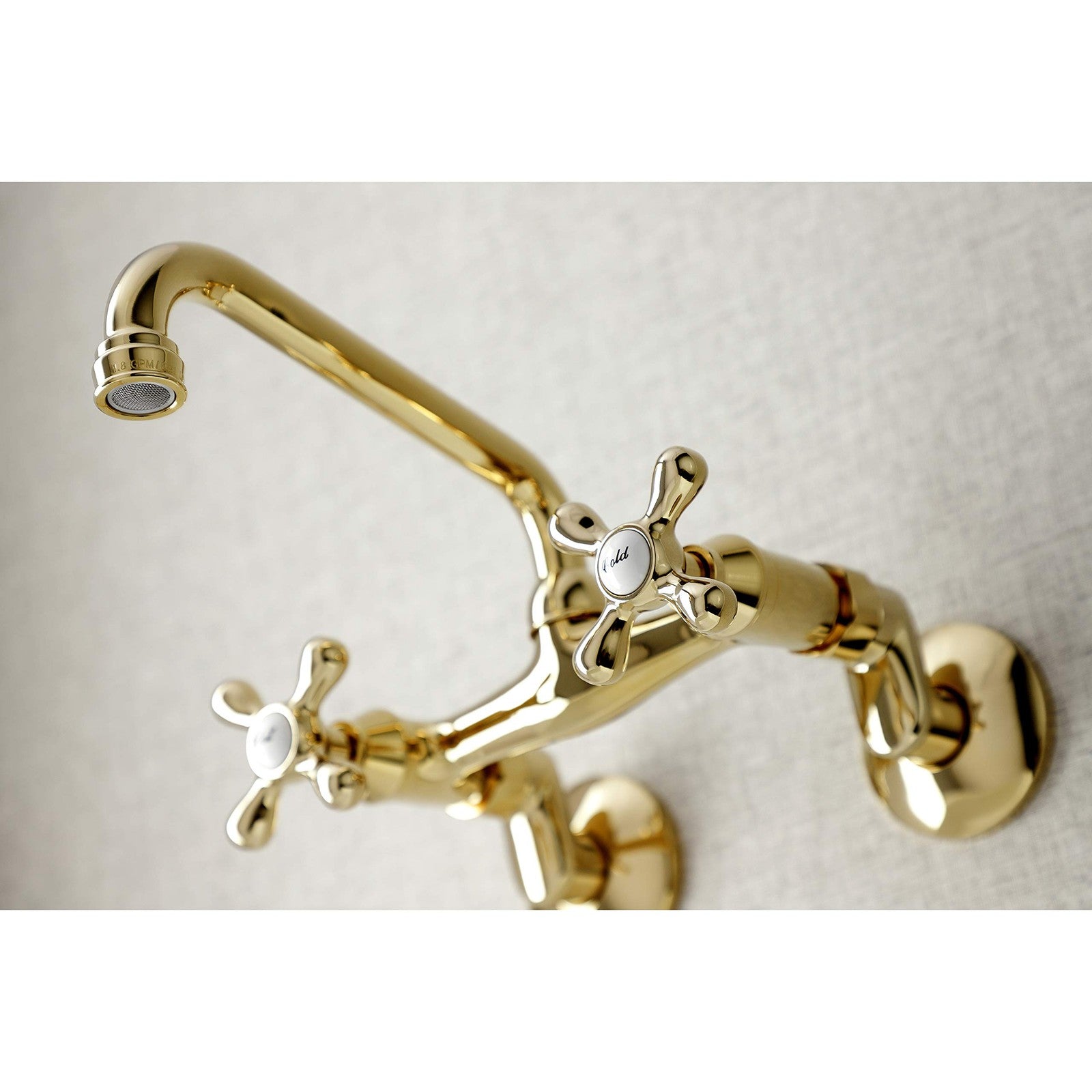Kingston Brass Victorian two-handle wall mount kitchen faucet with 7-inch spout and polished finish.