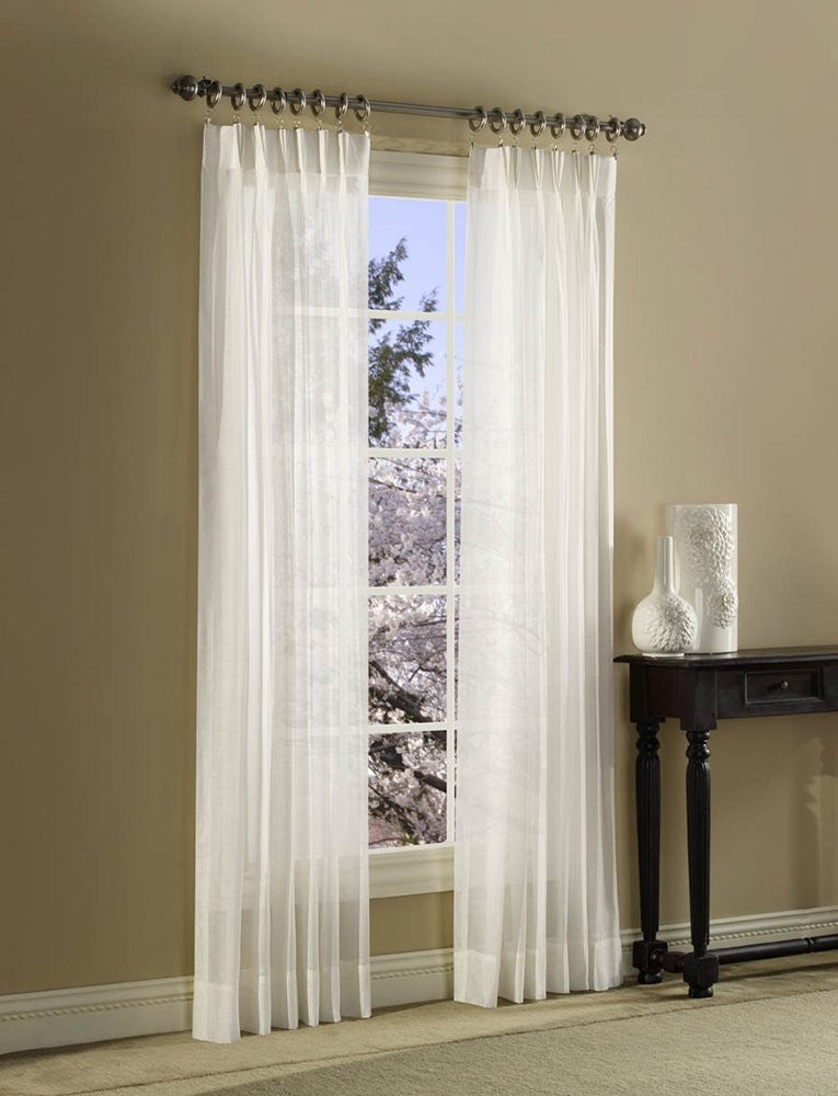 Pair of white Stylemaster Splendor pinch pleated drapes, 36 by 84 inches, hanging with pleats and fabric folds visible.