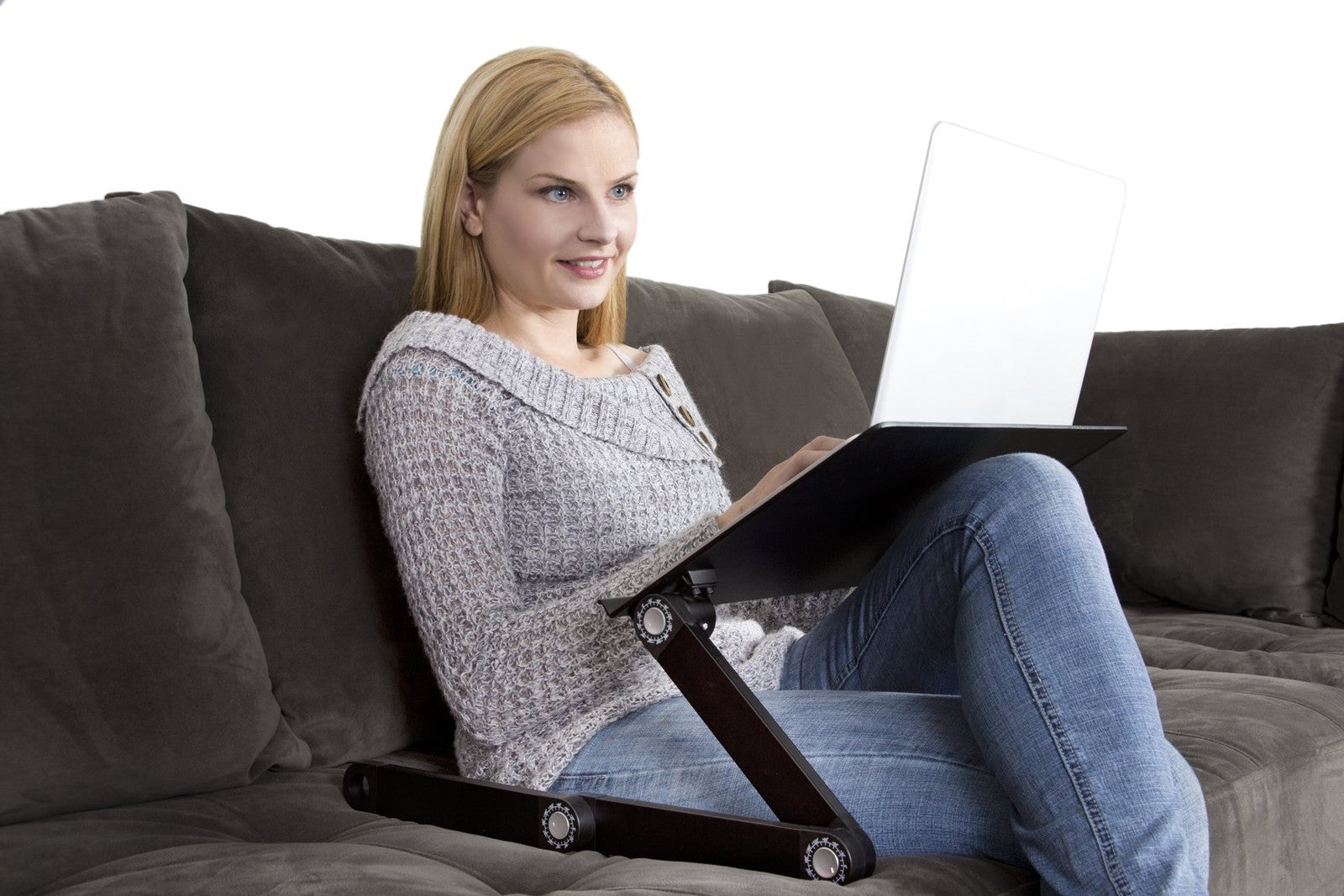 Uncaged Ergonomics WorkEZ adjustable laptop stand on a desk, showing its height-adjustable and ergonomic design for laptops.