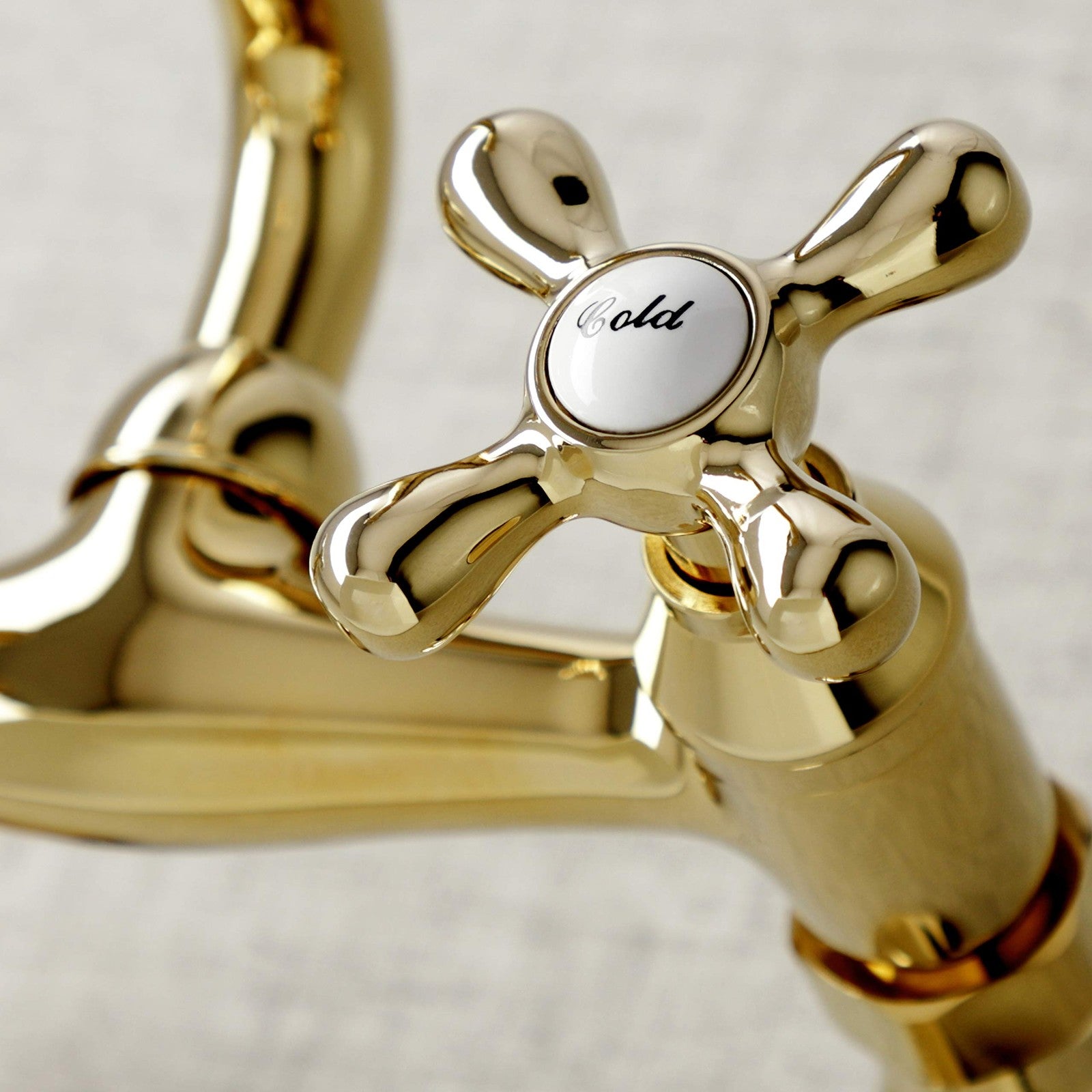 Kingston Brass Victorian two-handle wall mount kitchen faucet with 7-inch spout and polished finish.
