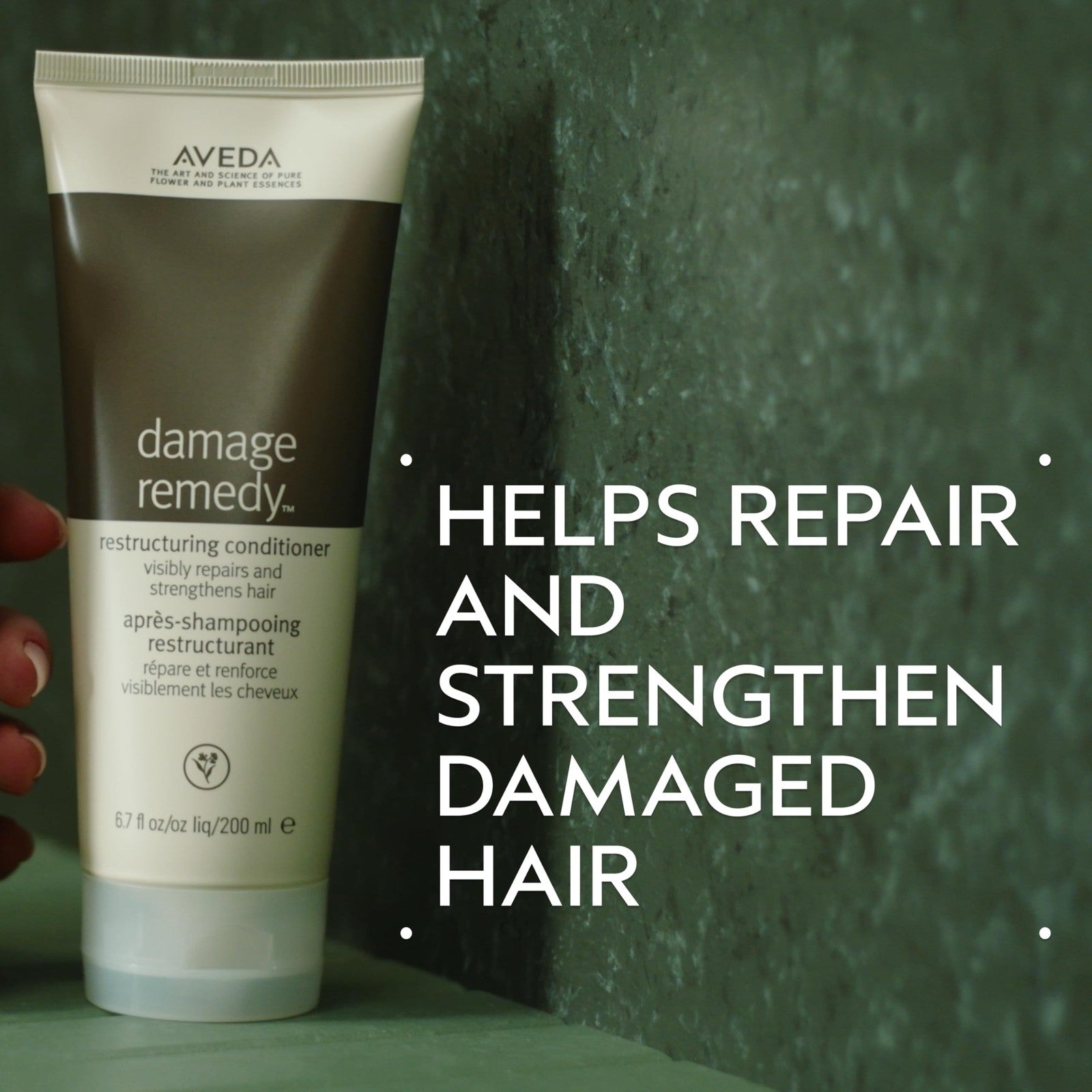 Aveda Damage Remedy Restructuring Conditioner for damaged hair, showing a sleek bottle with green and white packaging.