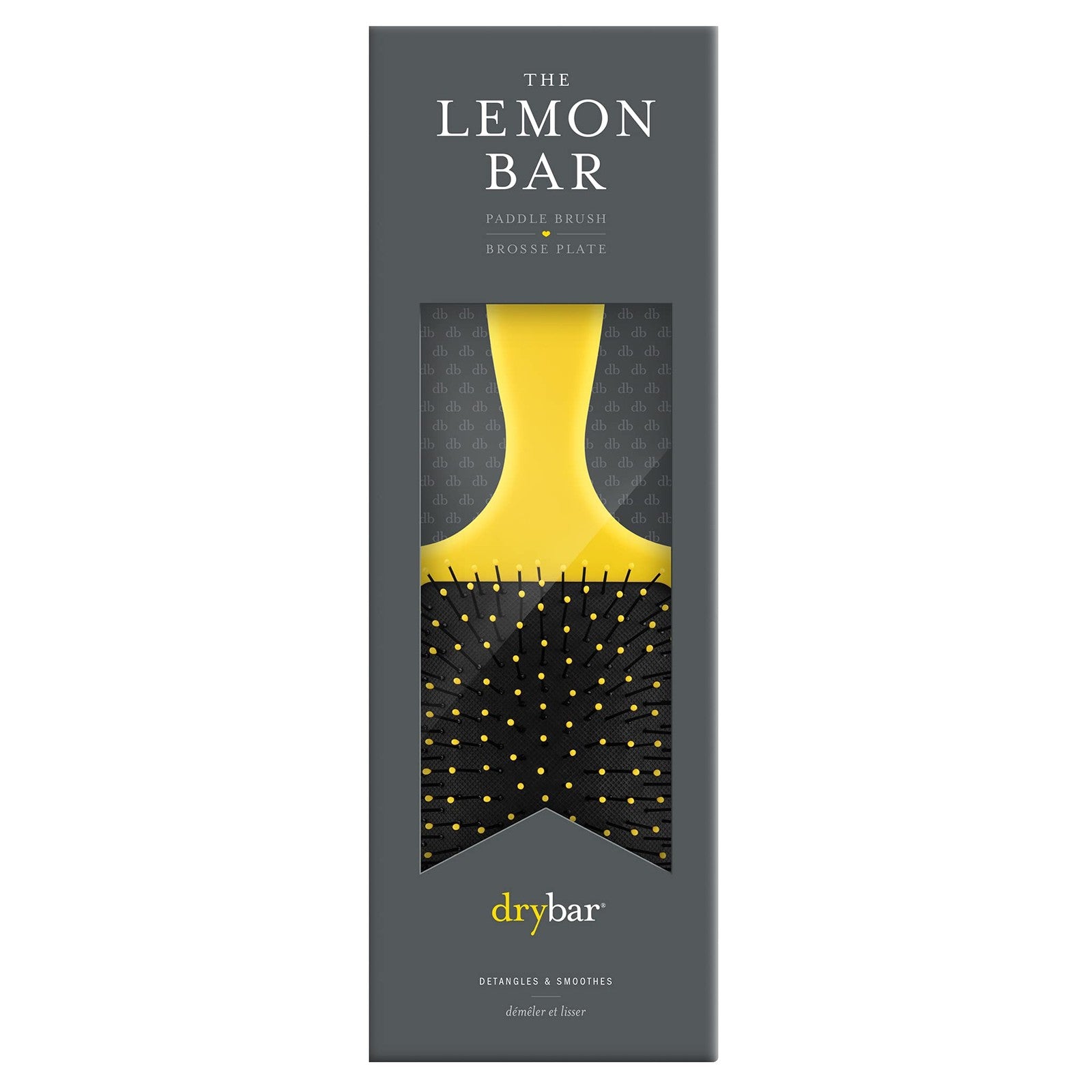 Drybar The Lemon Bar paddle brush with bright yellow handle and wide bristles for smooth, detangling hair styling.