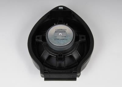 GM Genuine Parts front door radio speaker, black and circular with mounting bracket, designed for vehicle audio system.