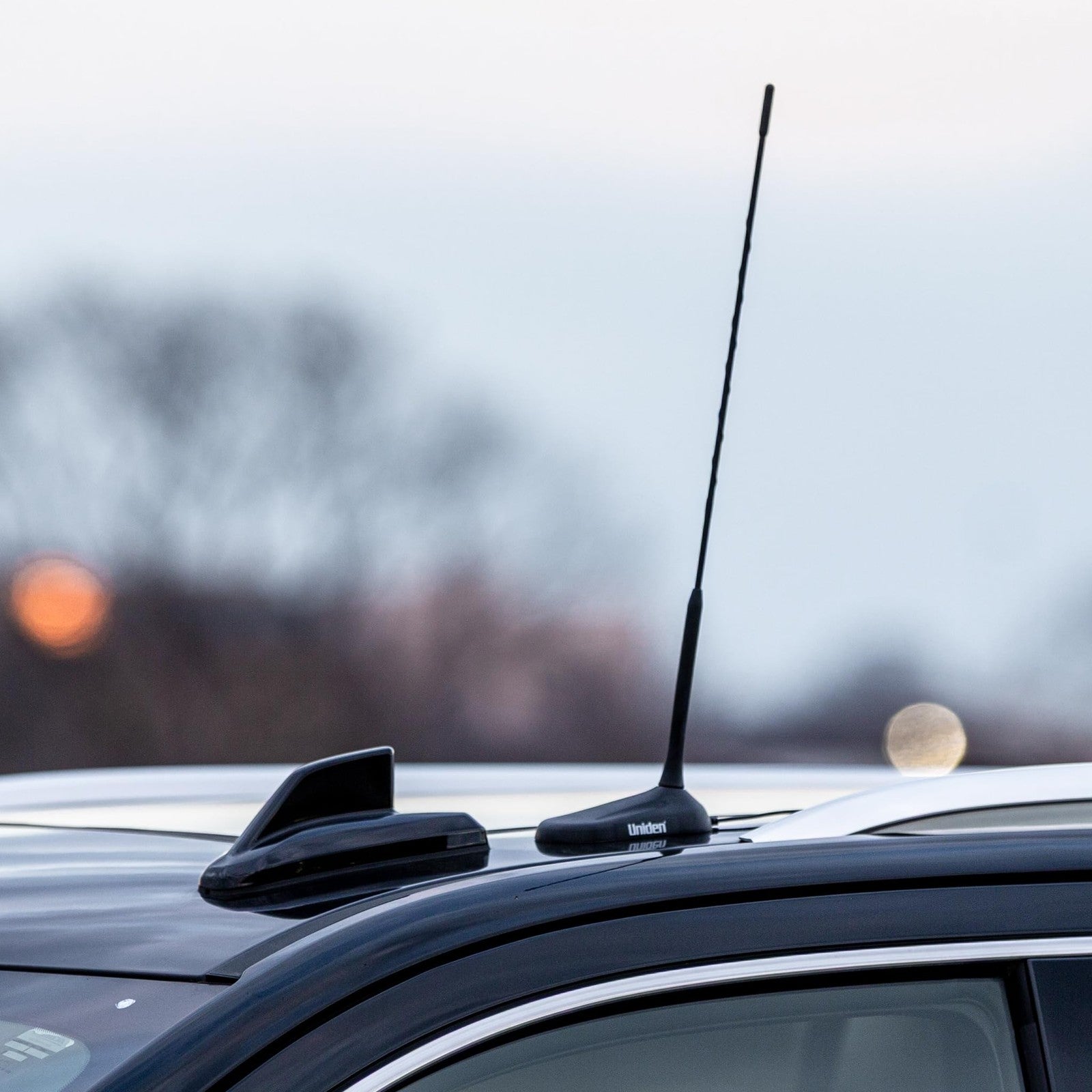 Uniden 18-inch magnetic CB radio antenna with low-profile aerodynamic design, mounted on vehicle for enhanced radio reception.