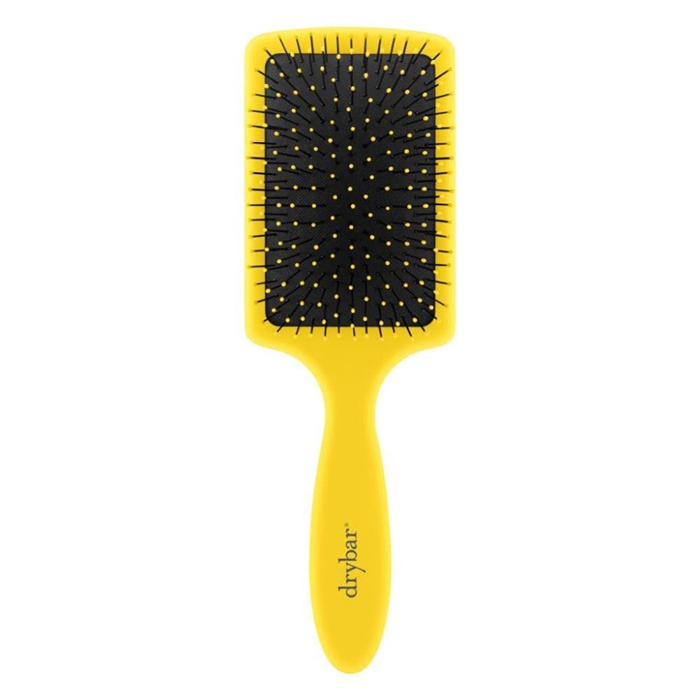 Drybar The Lemon Bar paddle brush with yellow handle and wide bristles for smoothing and detangling hair.