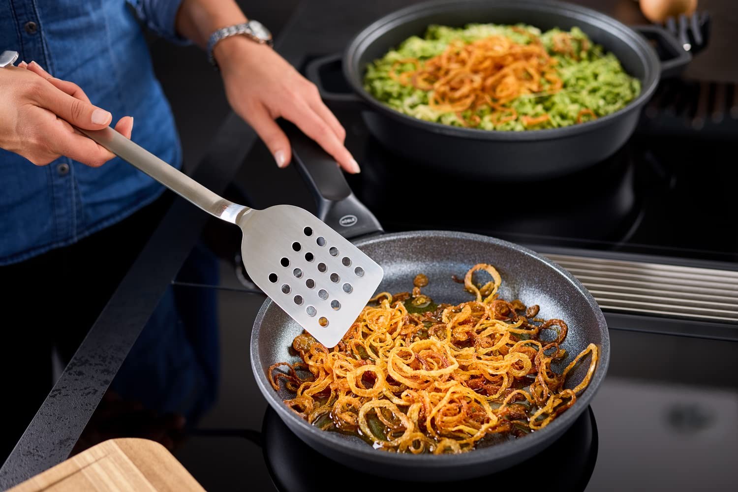 Rösle stainless steel perforated turner spatula, 13-inch, with a hook for kitchen cooking and flipping foods.