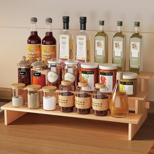 JinDoWin 3-tiered spice rack organizer for cabinet, displaying neatly arranged spice jars on a kitchen shelf.