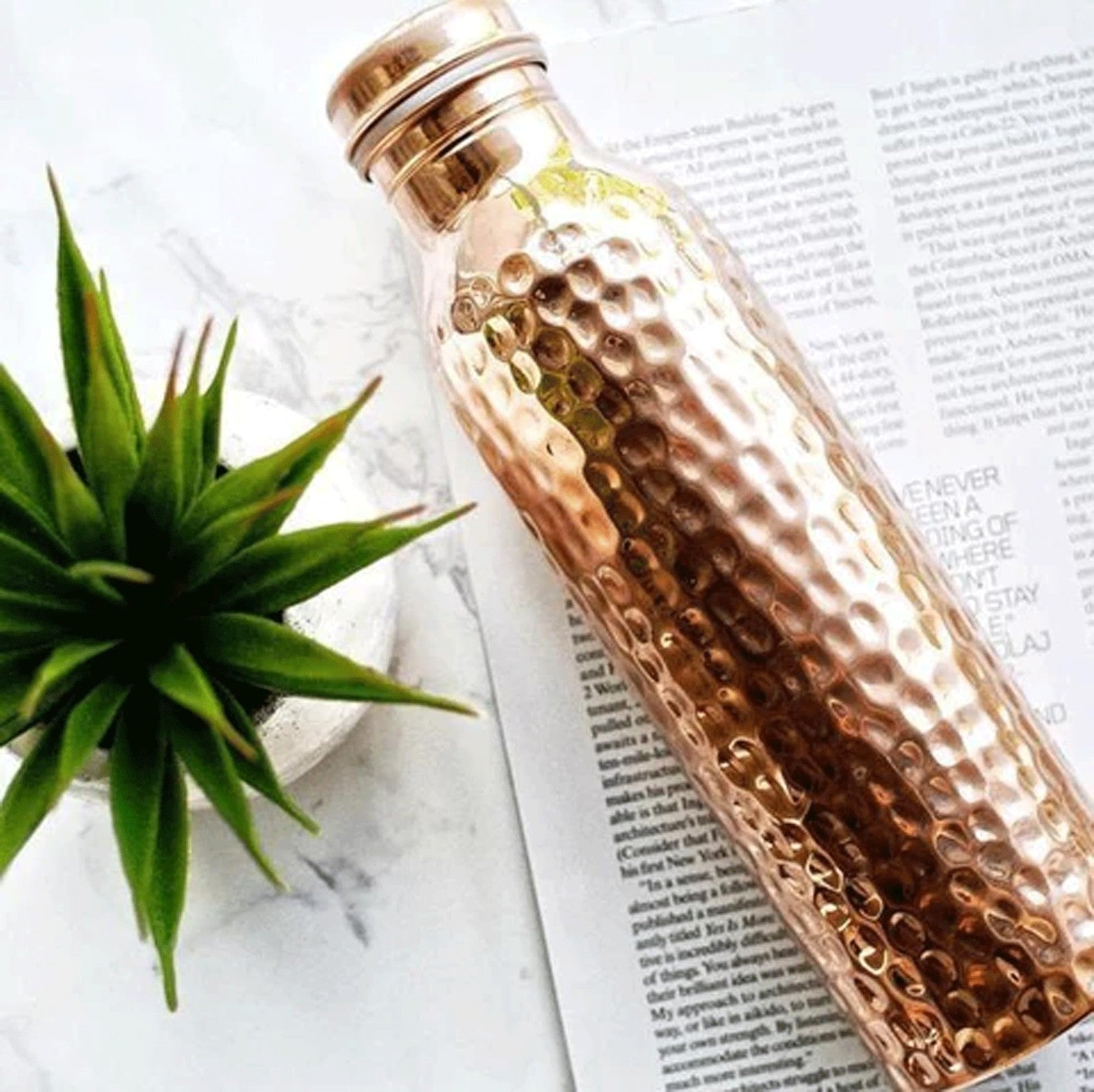Hammered copper water bottle by Unbranded, traditional Ayurvedic pure copper vessel with a rounded design and polished finish.