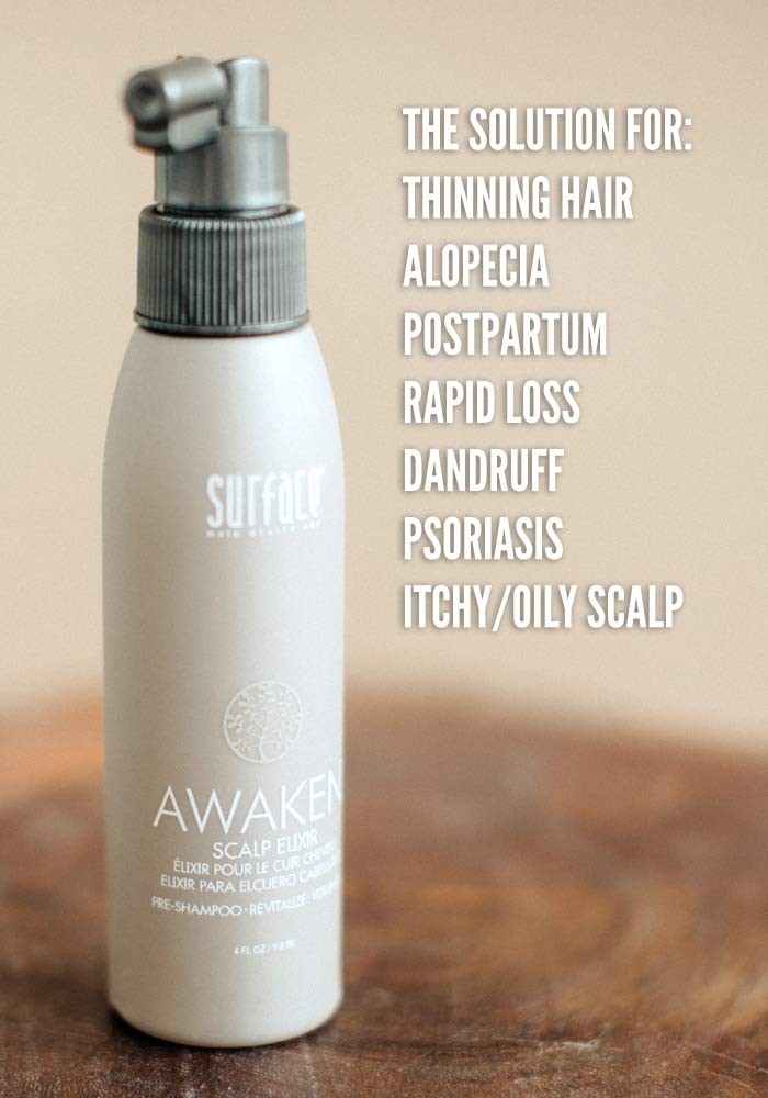 Surface Hair Awaken Therapeutic Scalp Elixir with natural ingredients for thinning hair, shown in a clear glass bottle with a dropper.