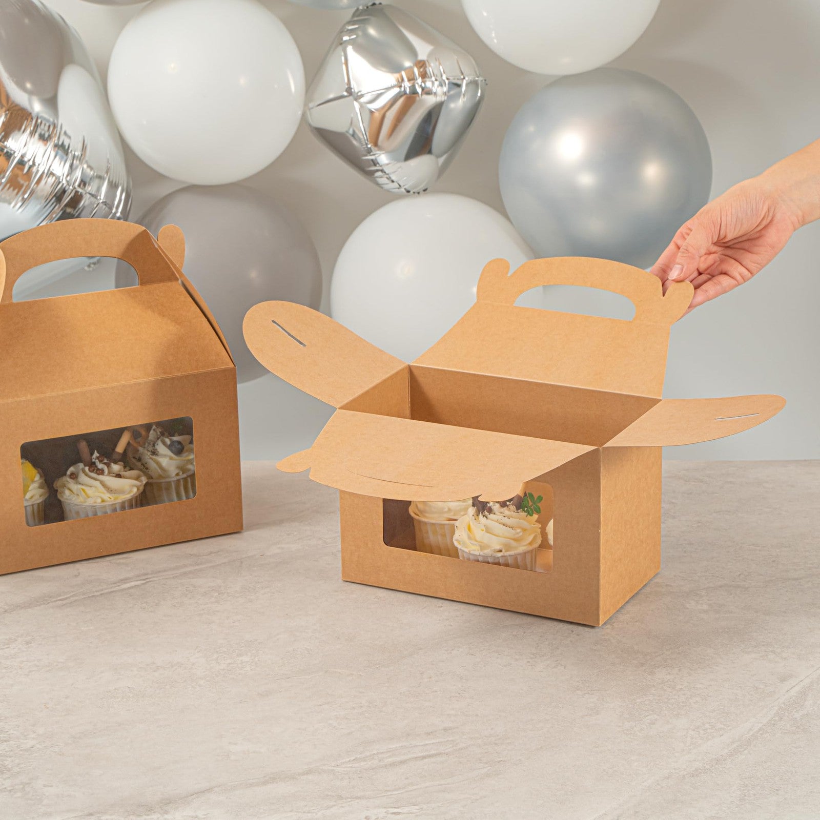 Bio Tek gable boxes for party favors, 8.5 x 4.8 x 5.5 inches, made by Restaurantware, stacked with colorful gift items.