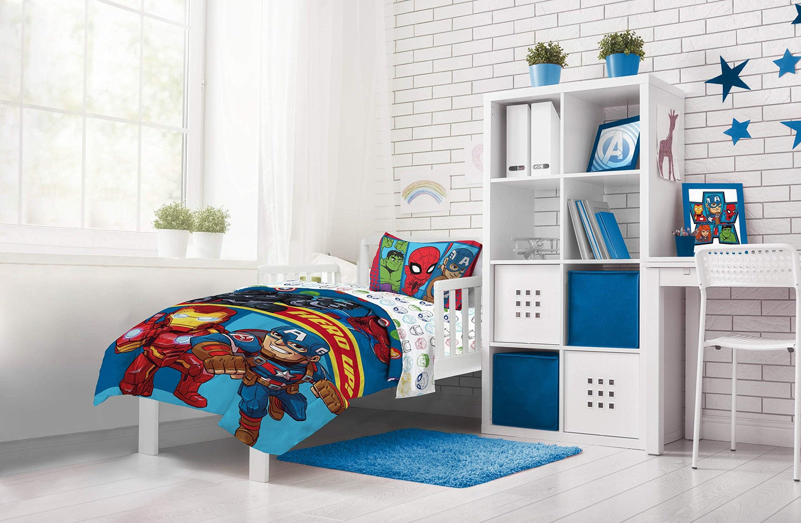 Jay Franco Marvel Super Hero Adventures toddler bed set with colorful superhero characters and themed bedding in a vibrant bedroom.