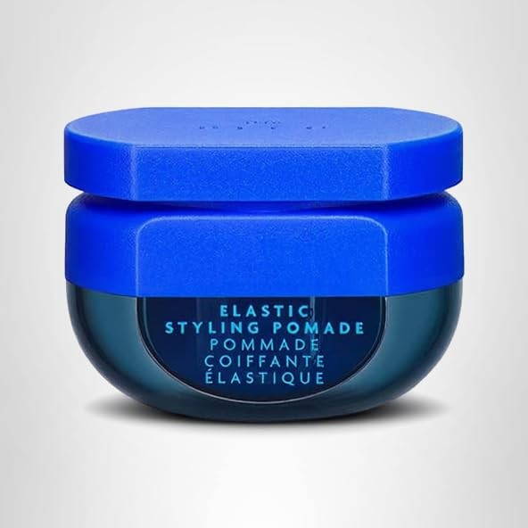 R+Co BLEU Elastic Styling Pomade jar with product label, showing the pomade's smooth texture and sleek packaging.