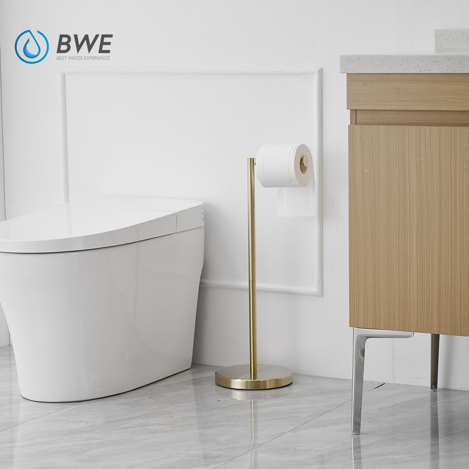 BWE brushed gold modern toilet paper holder stand with storage for tissue rolls, sleek bathroom accessory, on a clean bathroom surface.