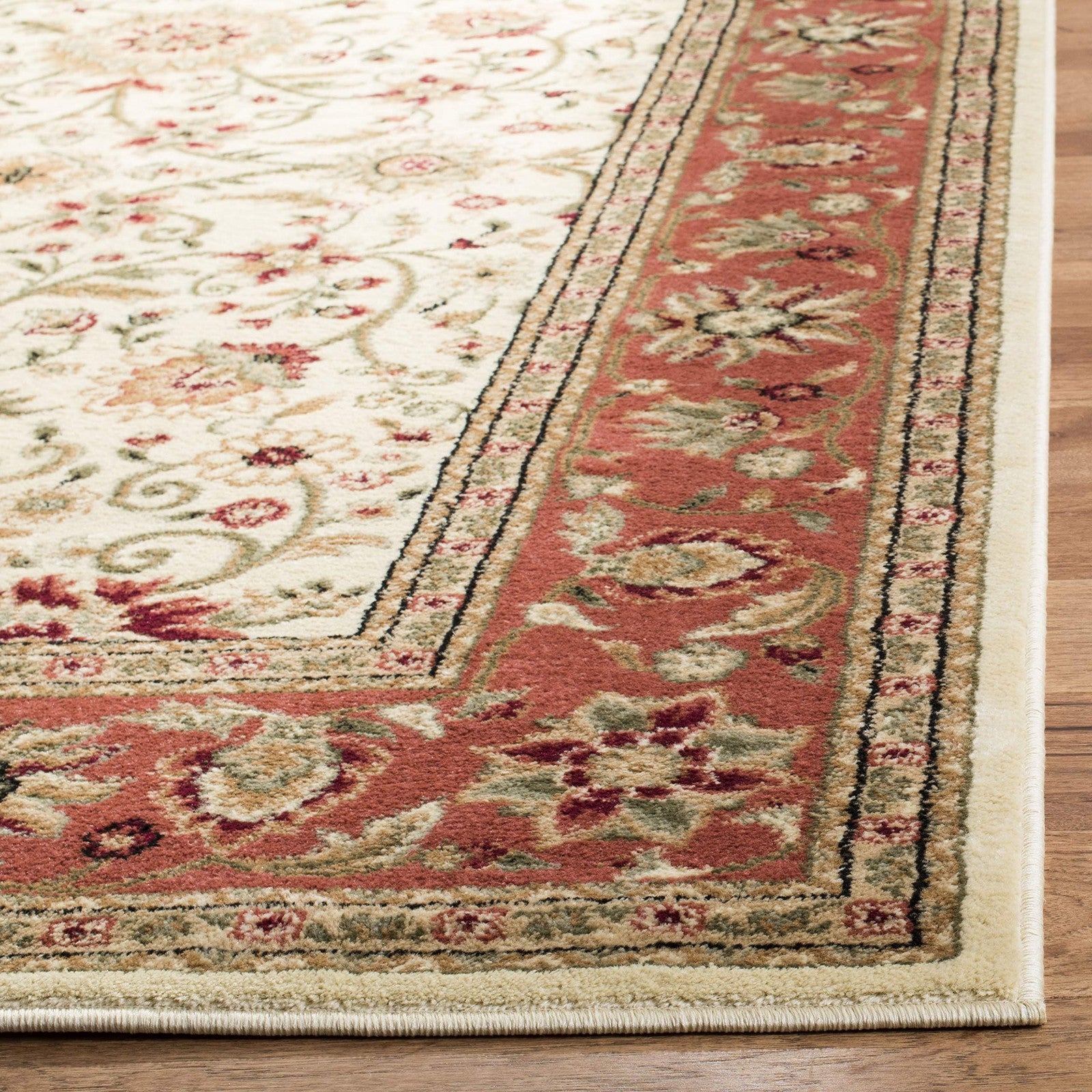 Safavieh Lyndhurst traditional accent rug in ivory and rust, measuring 33x53 inches, with intricate patterns and textured design.