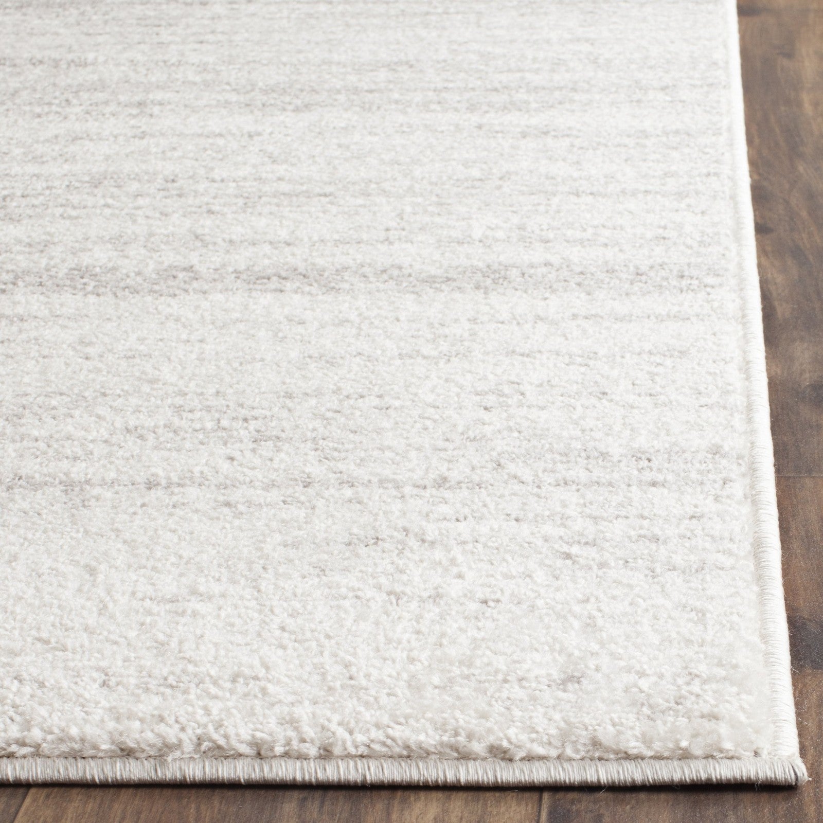 Safavieh Adirondack Collection ivory and silver modern ombre area rug with a square shape and contemporary design.