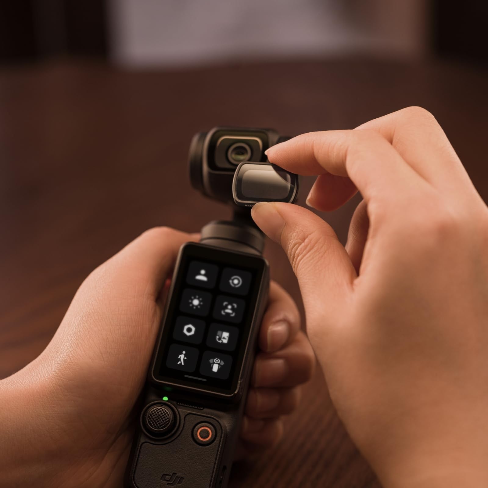 DJI Osmo Pocket 3 black mist filter attached to the compact handheld camera for softening video and photo effects.