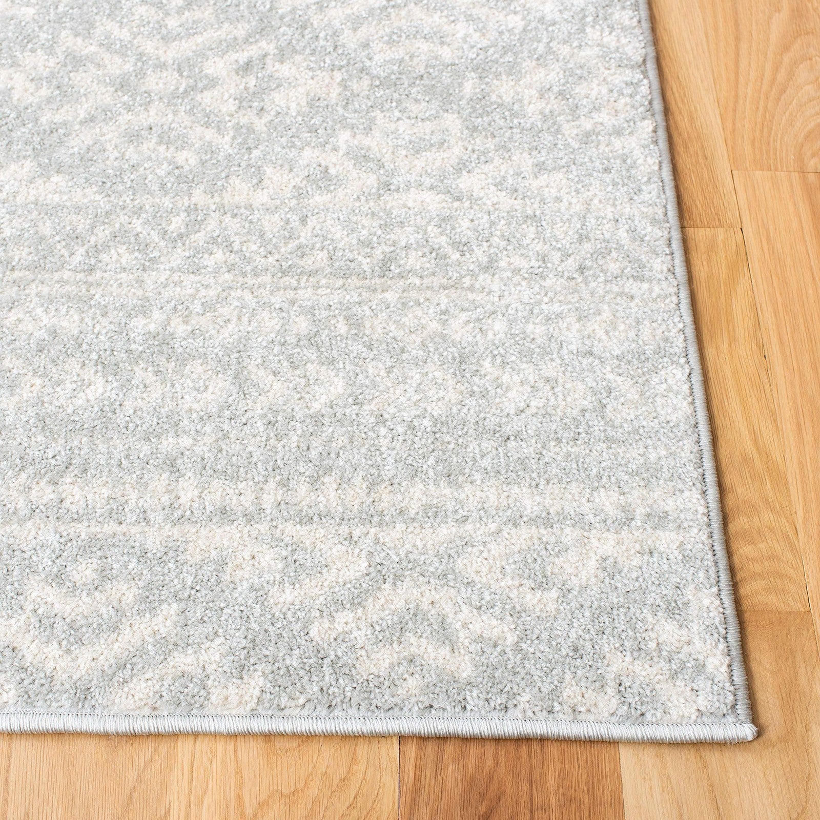 Light grey and ivory Safavieh Tulum Collection accent rug with Moroccan boho pattern, measuring 2x5 feet, placed on a wooden floor.