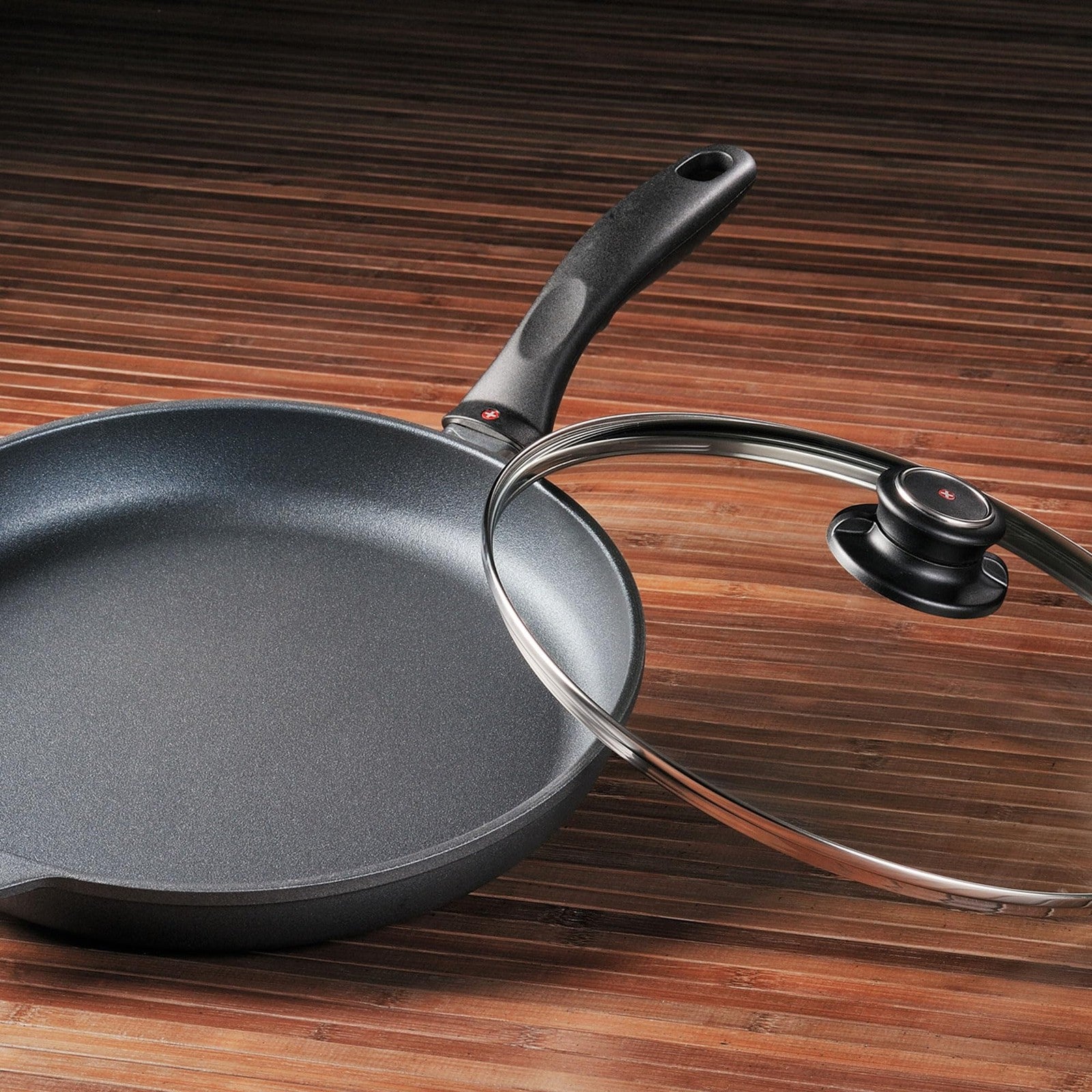 Swiss Diamond nonstick frying pan with lid, featuring diamond-coated nonstick surface for easy cooking and cleaning.