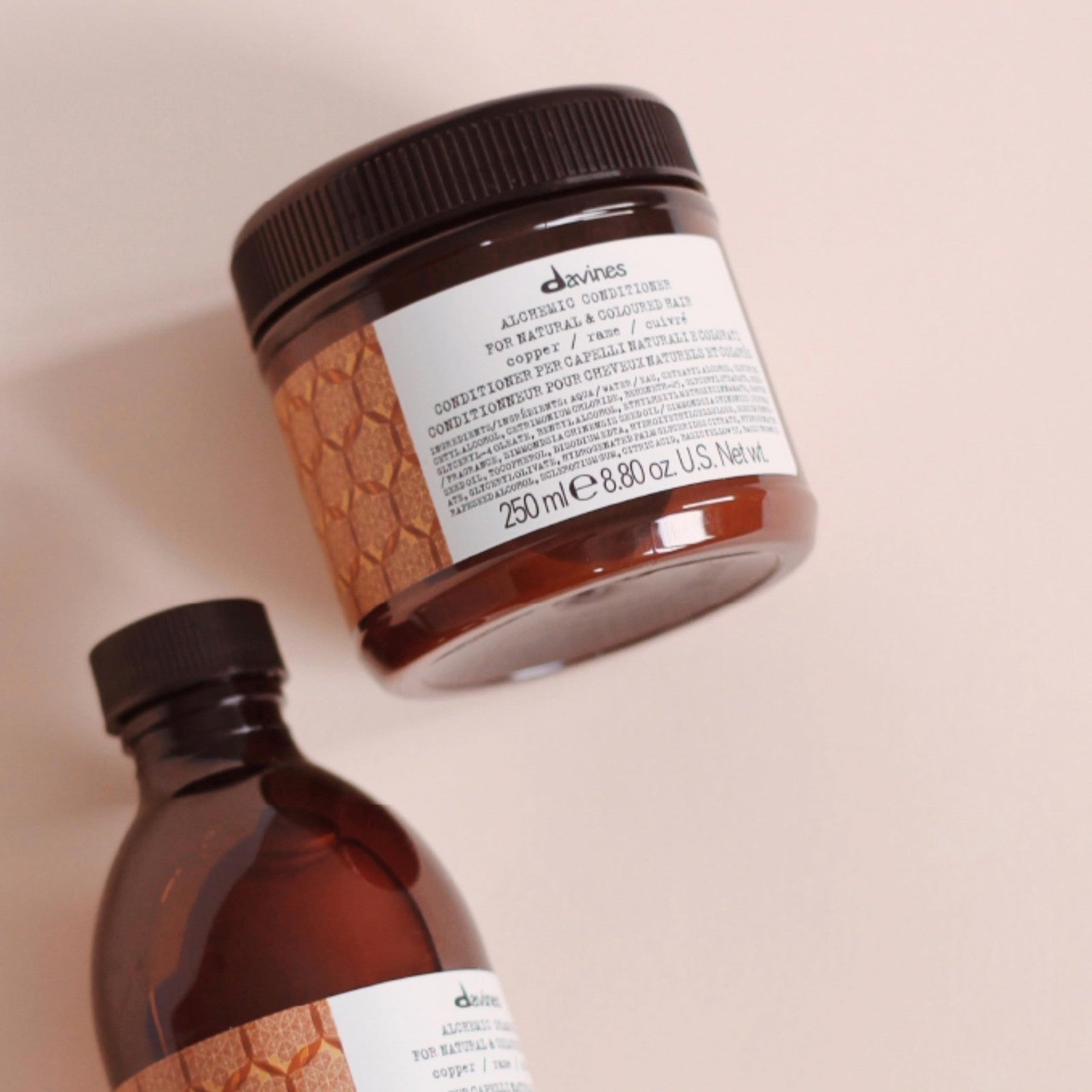 Davines Alchemic Copper Conditioner in 8.81 oz bottle, showing the packaging with copper-colored label and product details.
