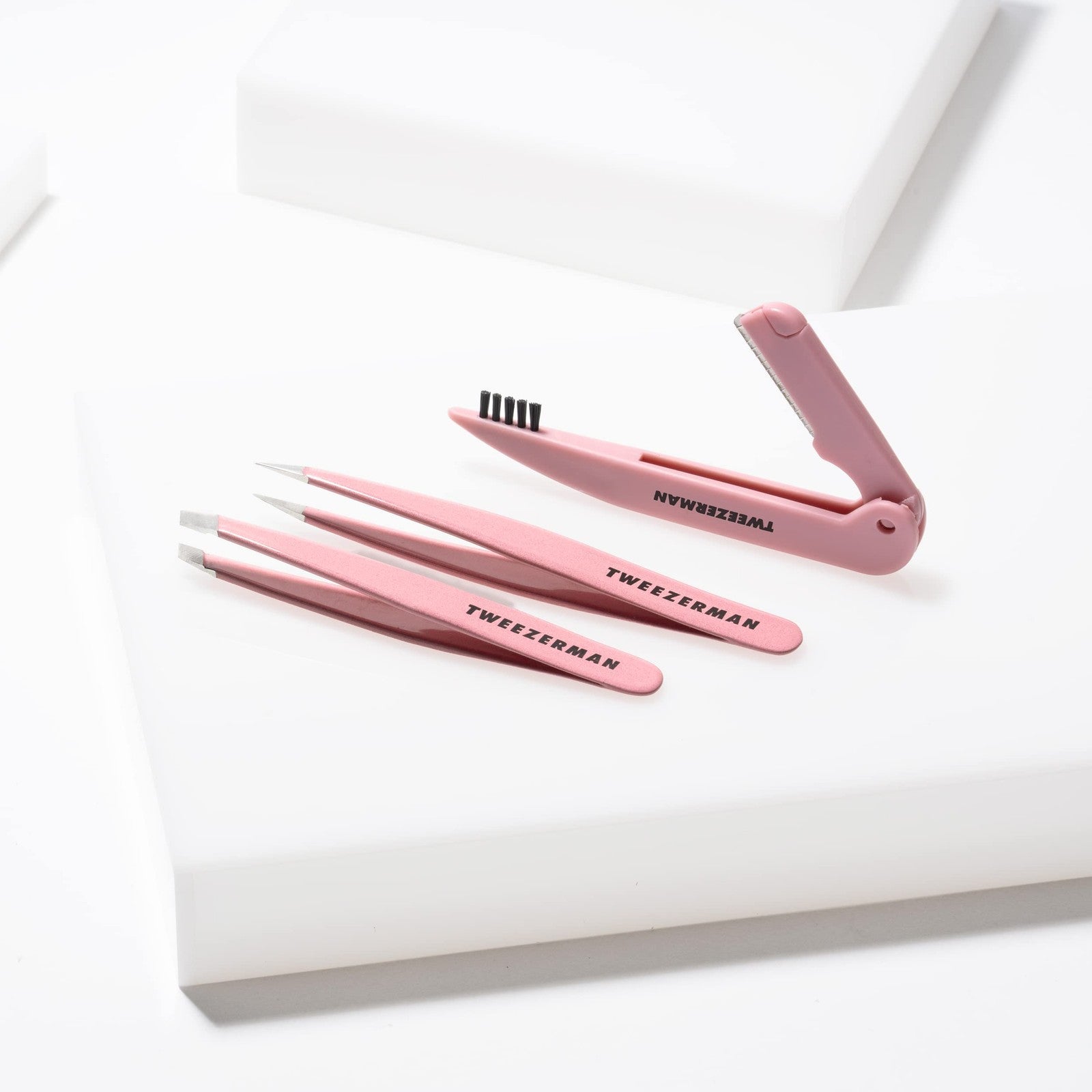 Tweezerman Tea Rose Brow Sculpting Set includes tweezers, brush, and brow gel for shaping and defining eyebrows.