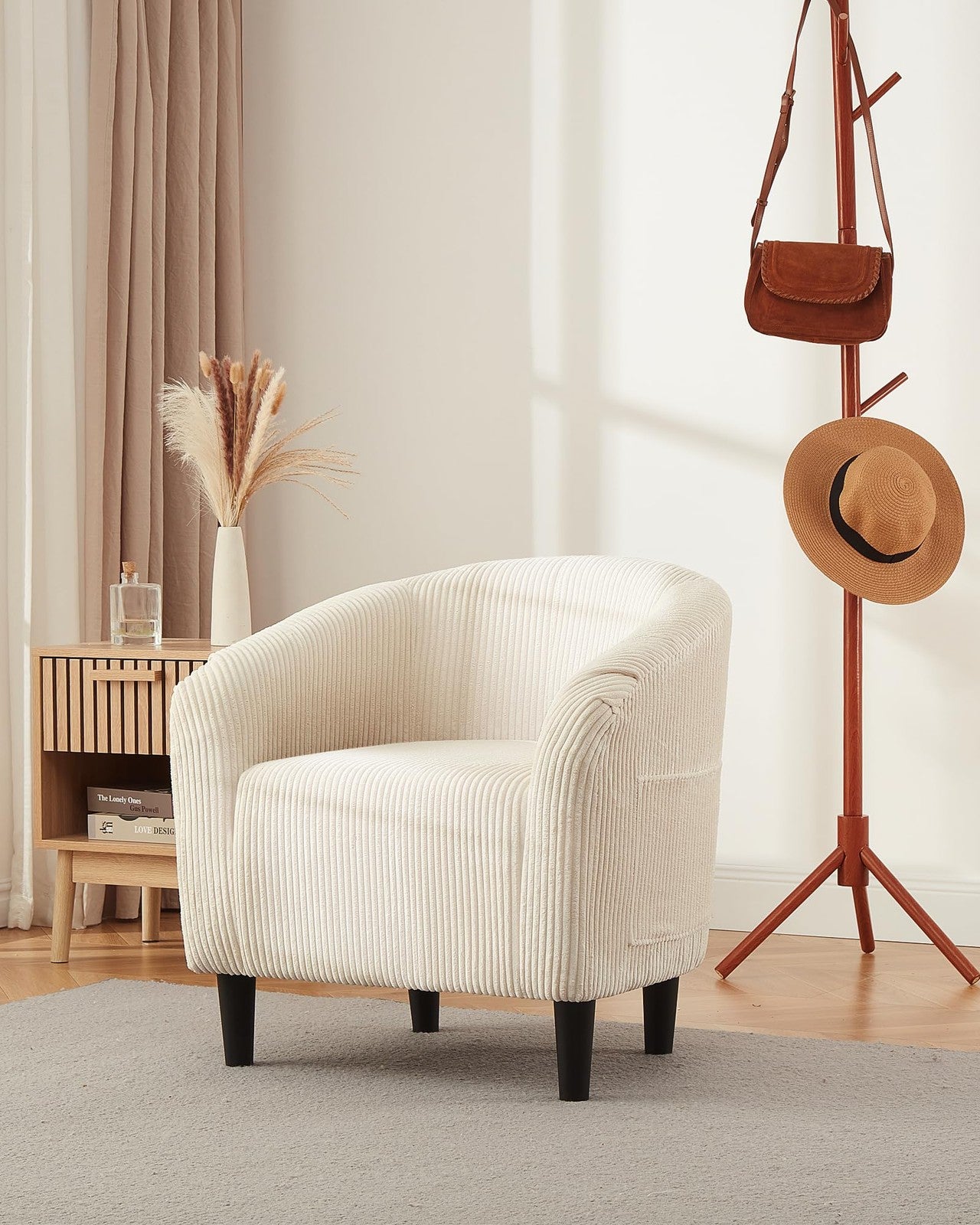 Corduroy barrel accent chair with elegant armrests and cozy design, featuring a stylish and comfortable club chair in neutral tones.