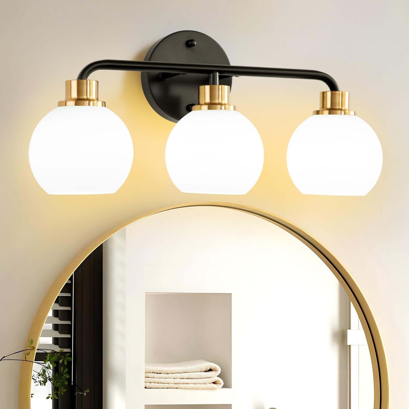 Watyo 3-light bathroom vanity light fixture with black and gold finish and milk glass shades, ideal for modern bathroom decor