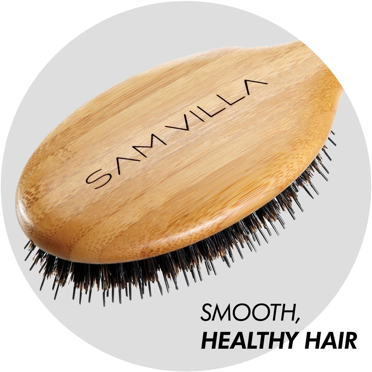 Sam Villa Signature Series boar bristle hair brush for styling, with natural wood handle and densely packed bristles for smooth hair.