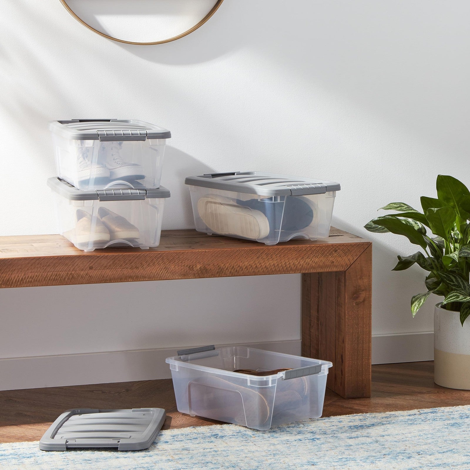 Stackable plastic storage containers with secure latching lids, ideal for organization and storage needs.