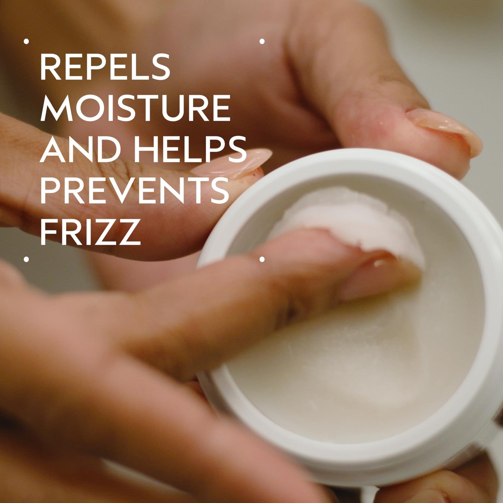 Aveda Brilliant Anti-Humectant Pomade jar showing the product label, designed to help prevent frizz and flyaways for sleek hair.