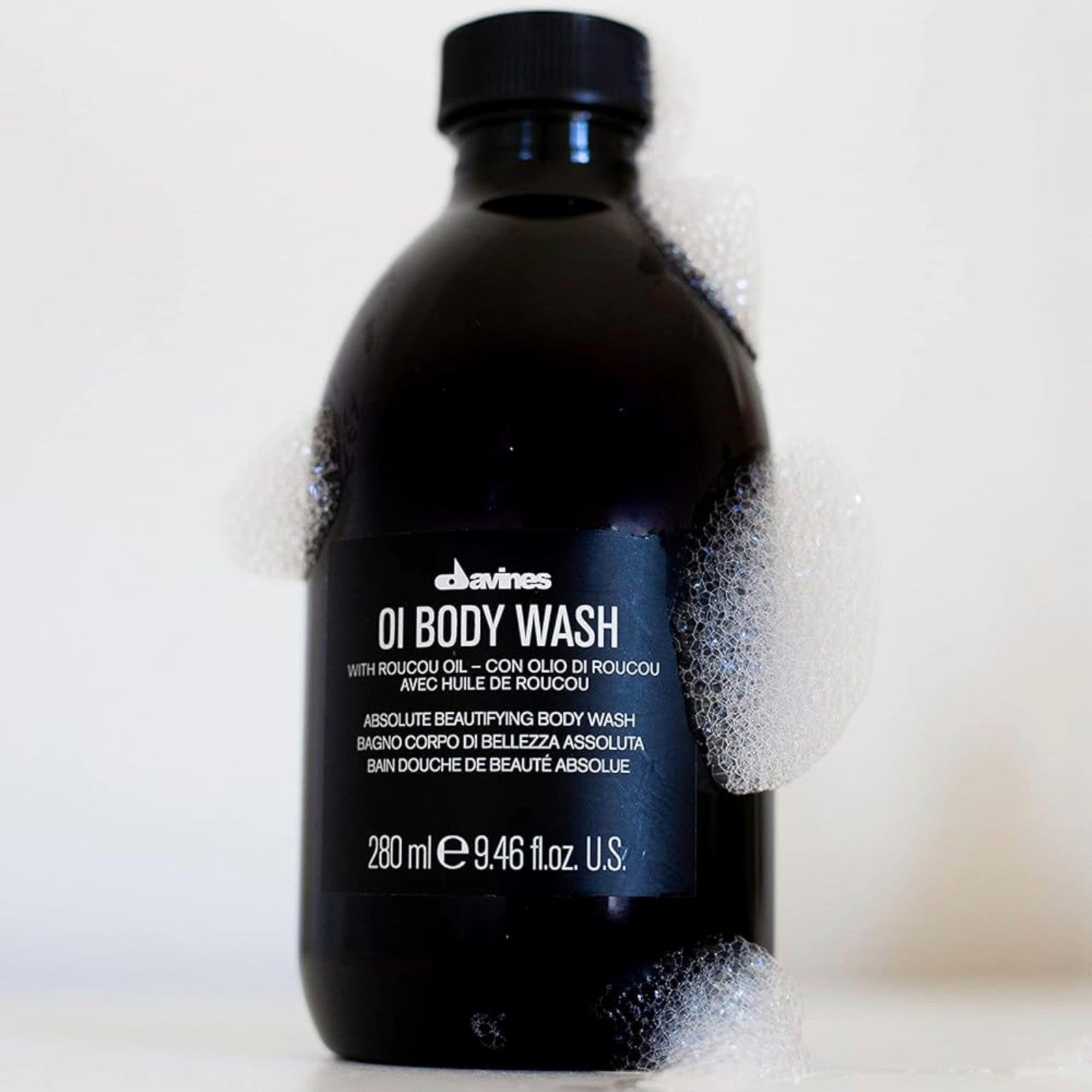 Davines OI Body Wash bottle with pump dispenser, featuring blue and white packaging, labeled with product name and ingredients.