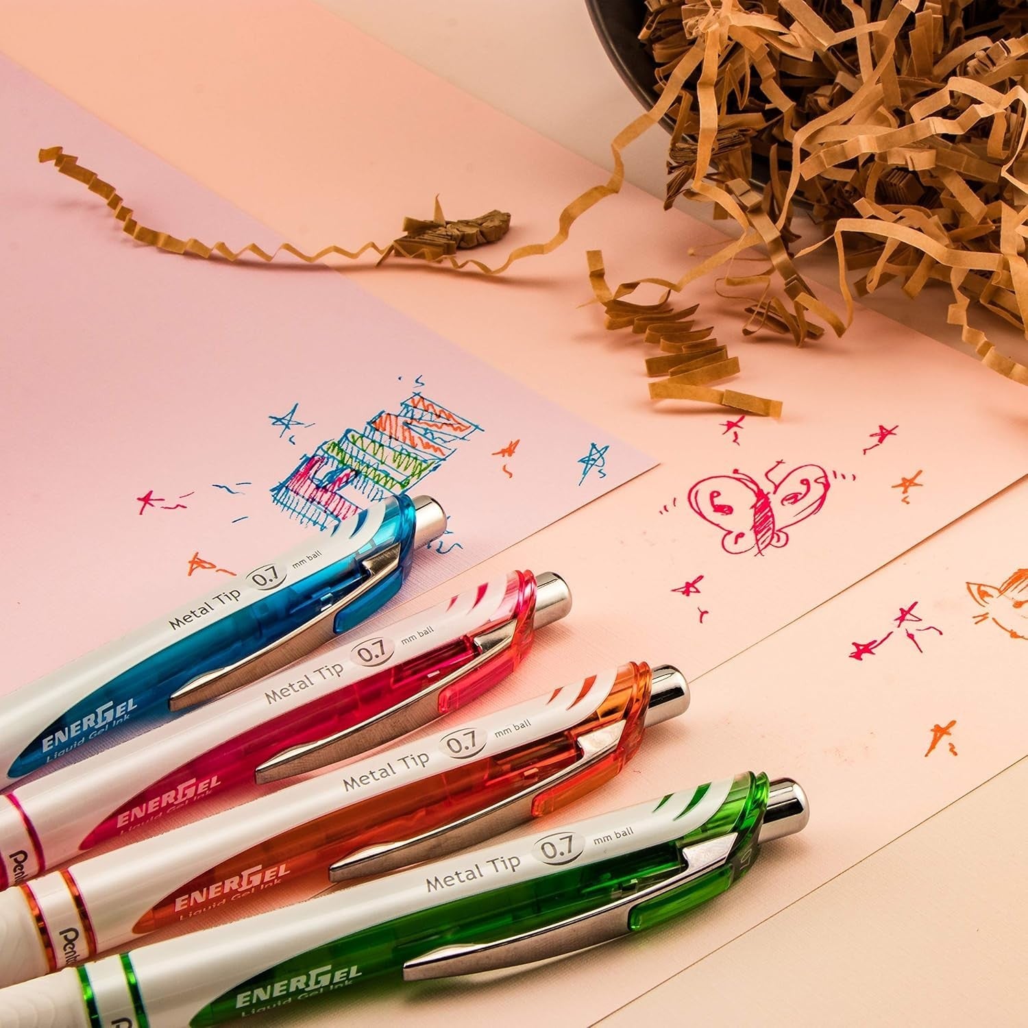 Pentel Energel Pearl medium point 0.7mm retractable metal tip pens, shown in a set with black ink and colorful barrels.