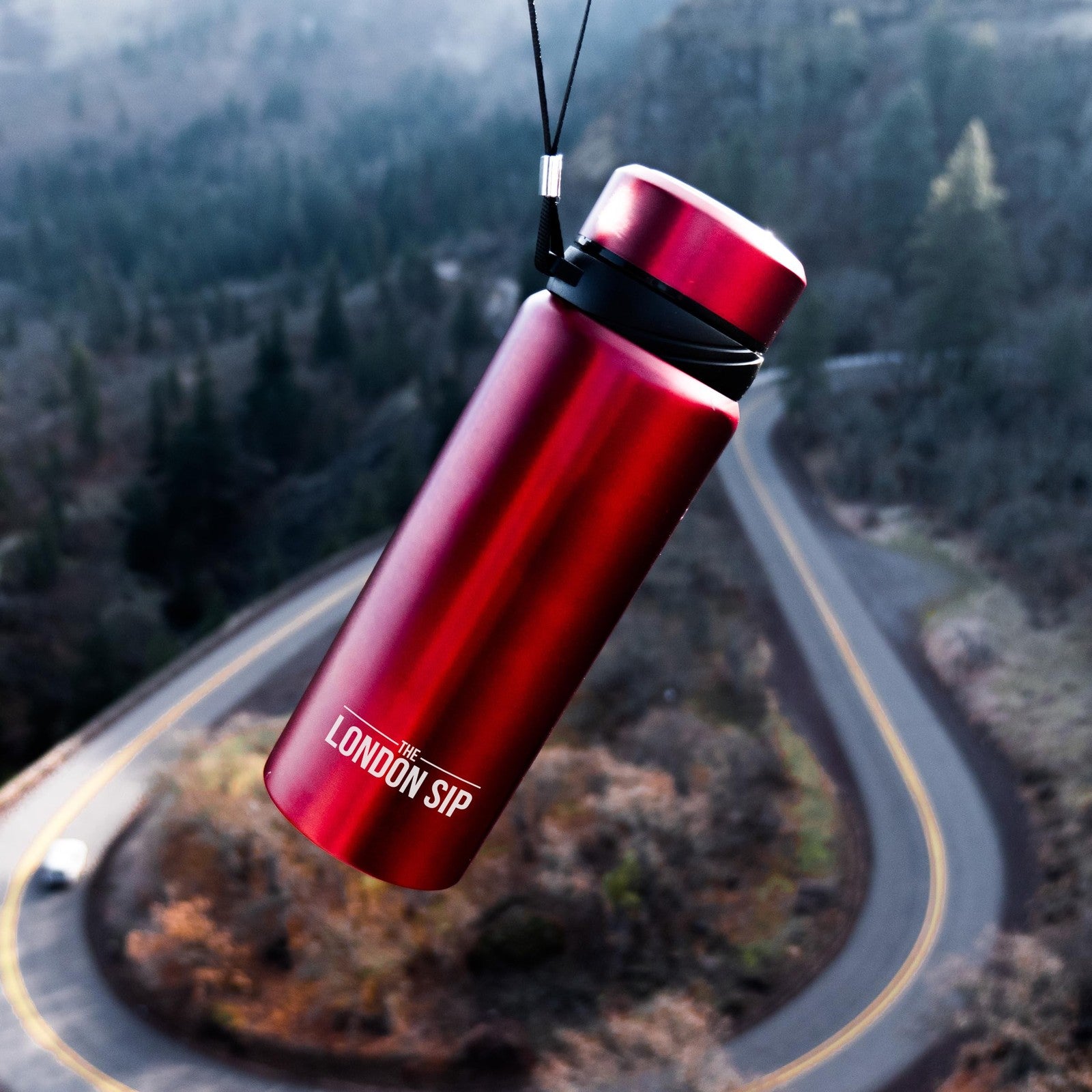 London Sip 25 oz travel mug with tea infuser and water bottle, stainless steel body, lid, and handle for on-the-go hydration.