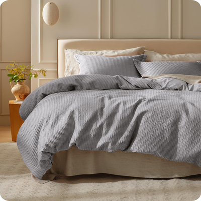 Bedsure queen cotton duvet cover with grey waffle weave design, made from 100% cotton, showcasing soft, textured bedding.