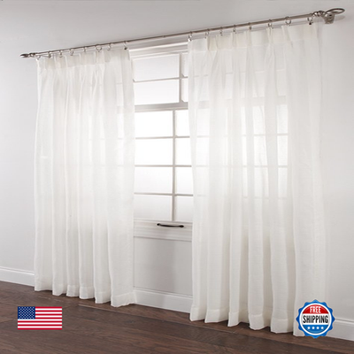 Pair of white Stylemaster Splendor pinch pleated drapes, 36x84 inches, hanging neatly on a curtain rod.