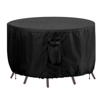 OutdoorLines waterproof round patio table furniture cover on a round outdoor couch, protecting outdoor furniture from weather.