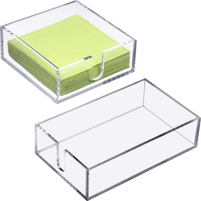 Clear acrylic Boao cocktail napkin holder on a table, designed for holding beverage napkins neatly and stylishly.
