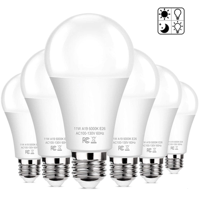 Six Brightever dusk-to-dawn LED A19 light bulbs, 11W, 100W equivalent, E26 base, shown in a natural lighting setting