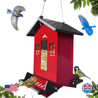 Red metal squirrel-proof bird feeder hanging outdoors, with 6-pound capacity, designed to attract and feed garden birds.