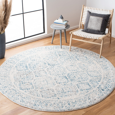 Round ivory and turquoise Safavieh Tulum Collection Moroccan boho area rug with intricate geometric patterns.