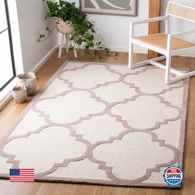 Handmade Moroccan Safavieh Cambridge Collection 5x8 ivory and beige area rug with intricate patterns and soft texture.