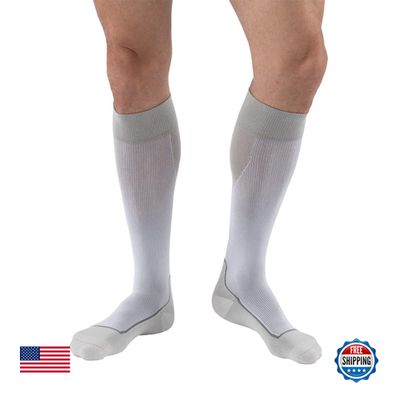 Jobst Sport knee-high compression socks in white and grey, X-Large size, designed for athletic support and improved circulation.